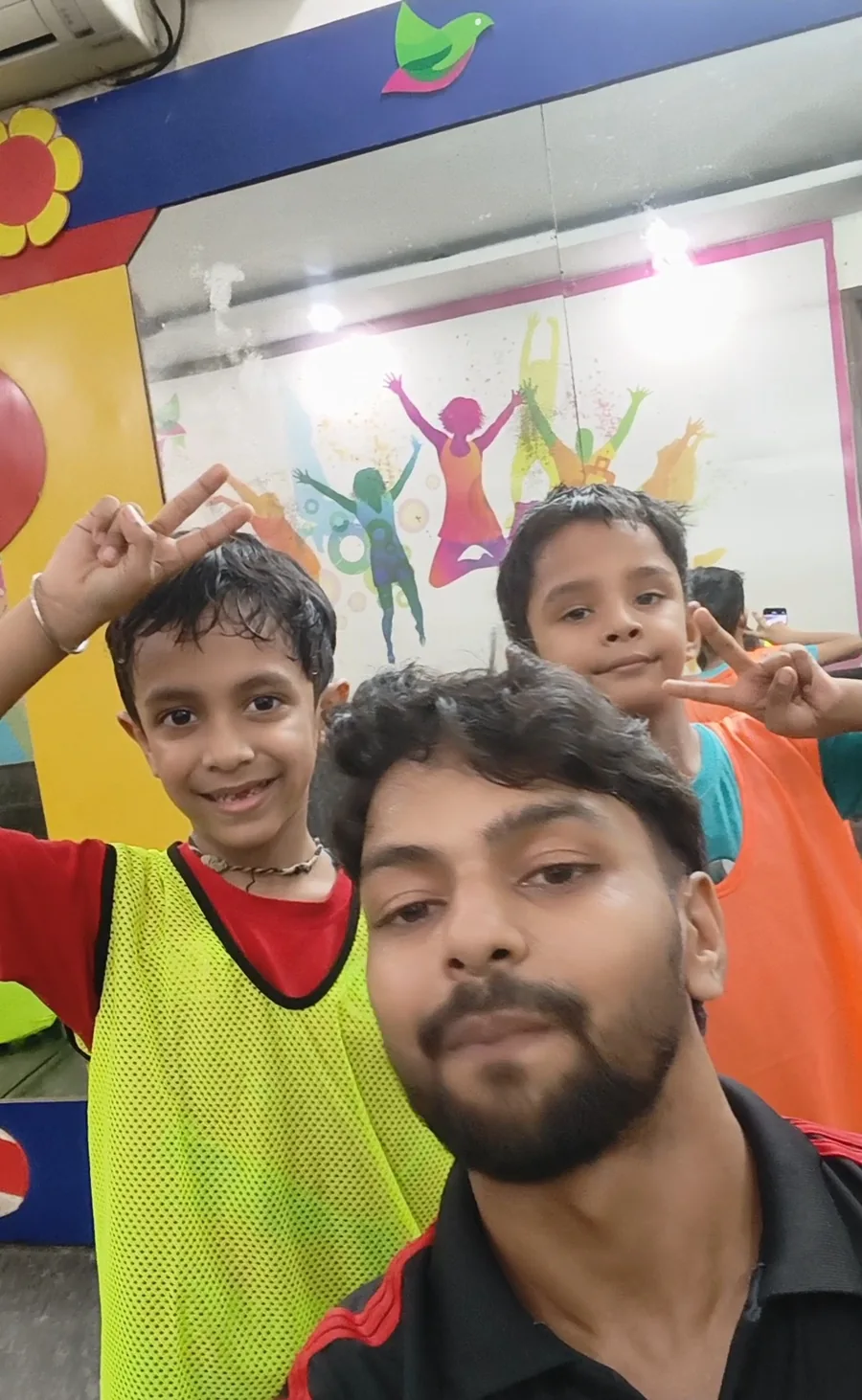 Children and a coach smiling after an activity session