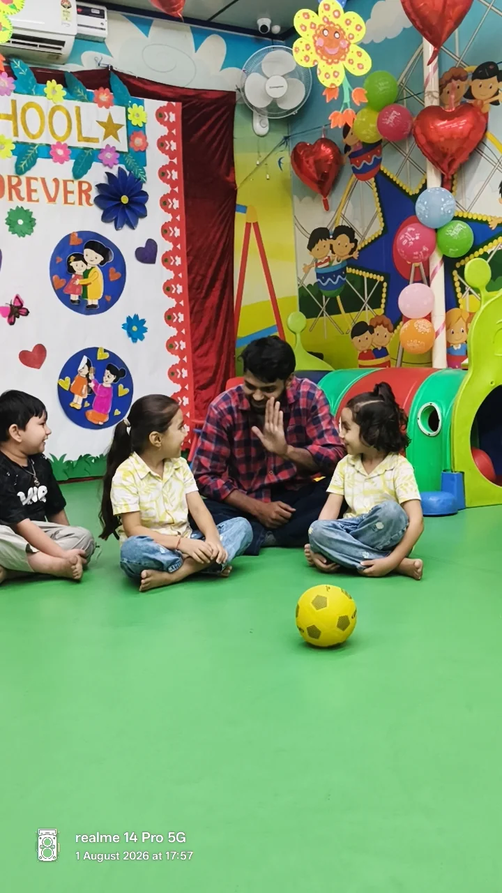 Children sitting together for a ball activity