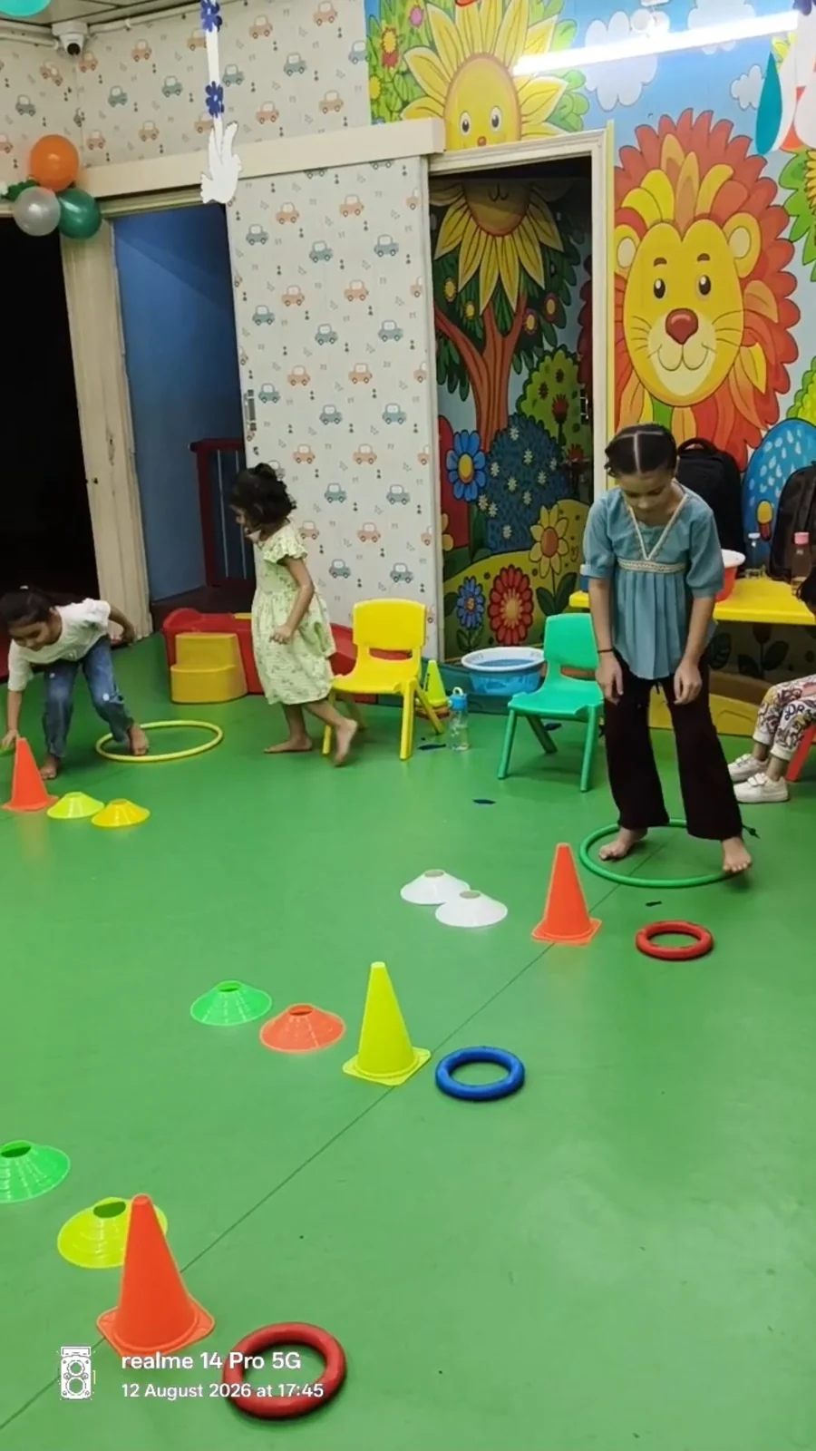 Children following a course of colourful cones