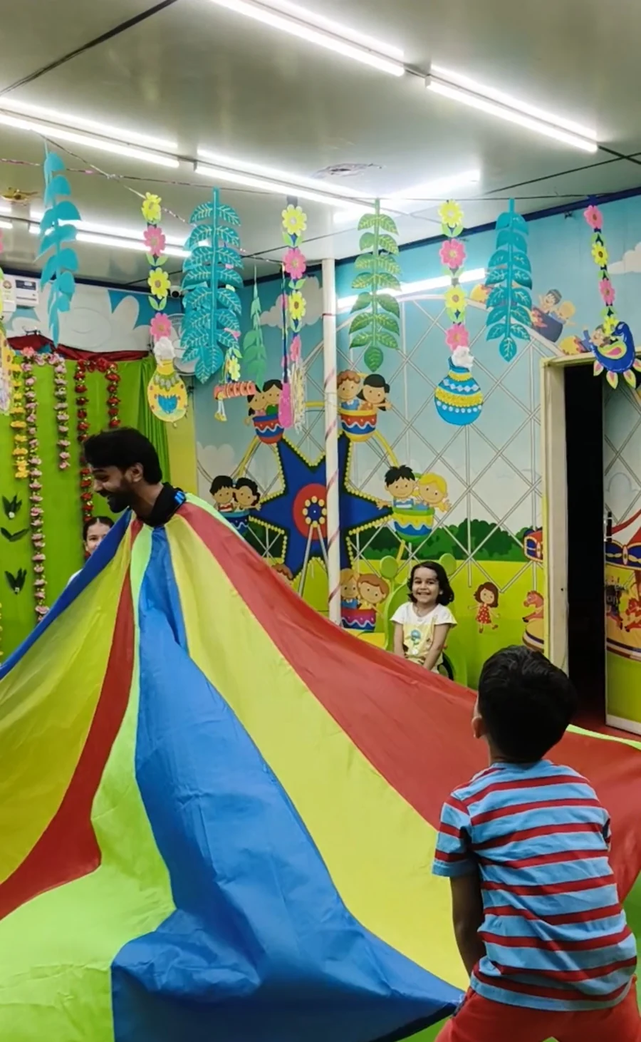A group parachute activity in the indoor play space